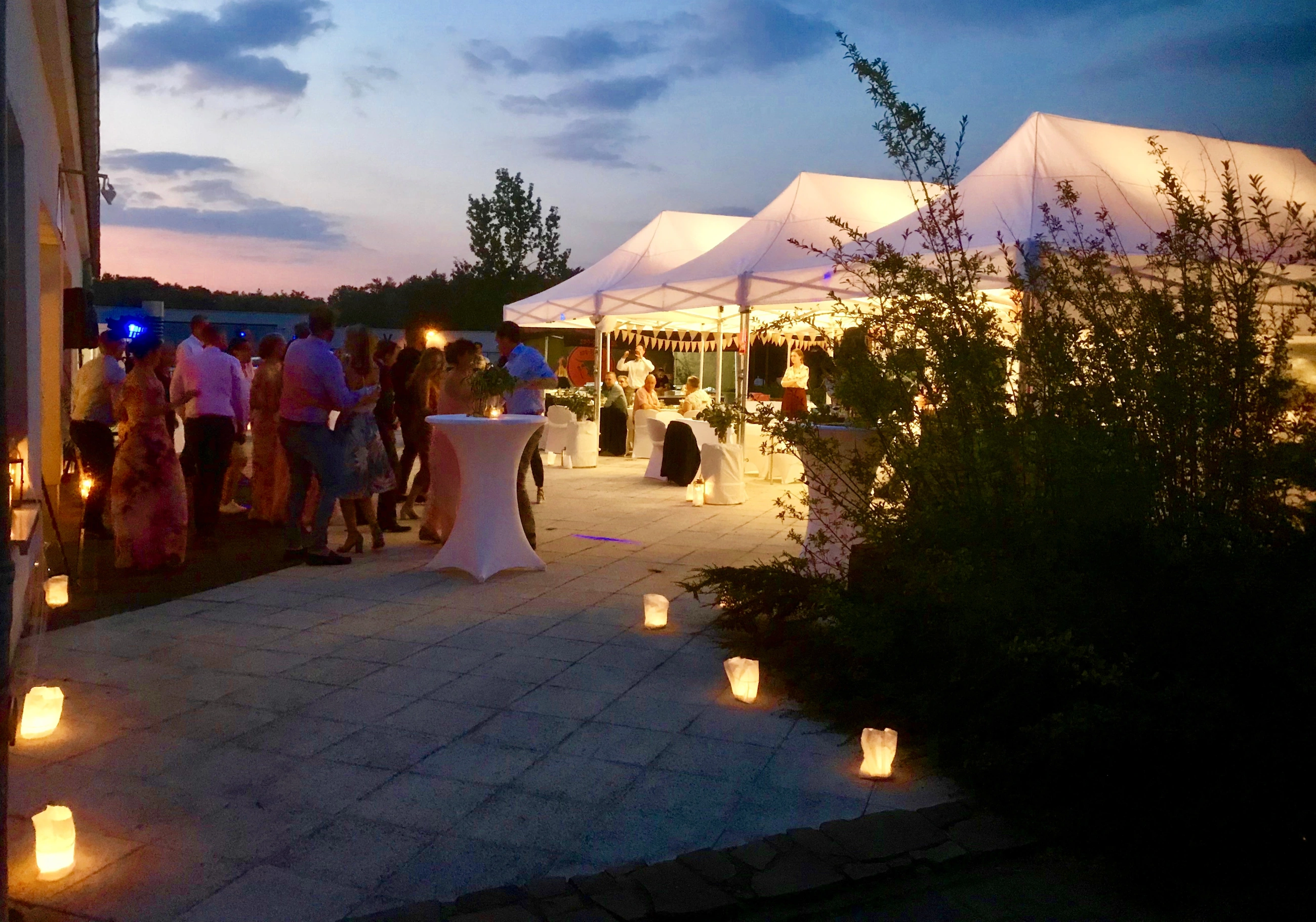 Feier auf der Terrasse mit beleuchteten Pavillons und Kerzen